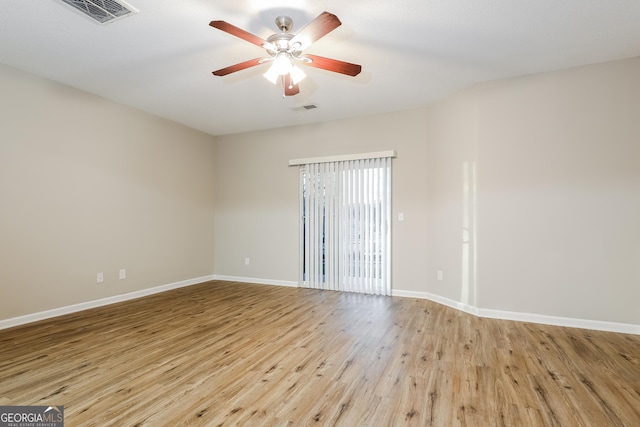 spare room featuring ceiling fan and light hardwood / wood-style floors