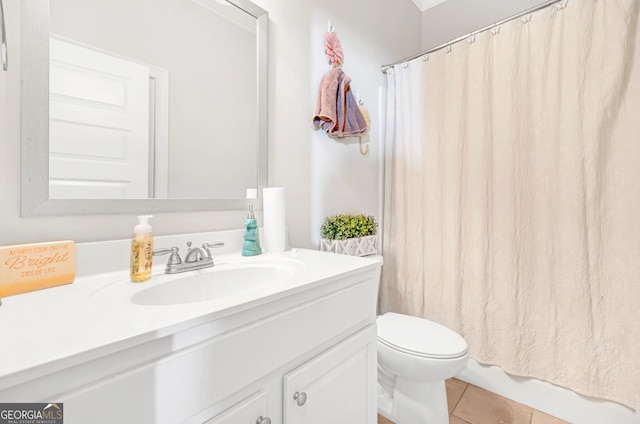 bathroom with a shower with curtain, vanity, toilet, and tile patterned flooring