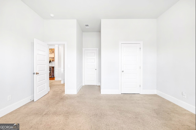 unfurnished bedroom with light carpet