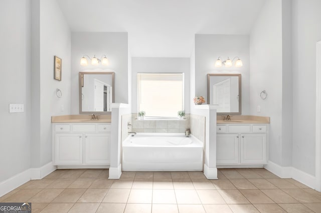 bathroom featuring a tub to relax in, tile patterned flooring, and vanity