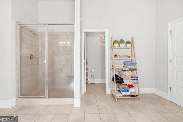 bathroom featuring an enclosed shower and tile patterned flooring