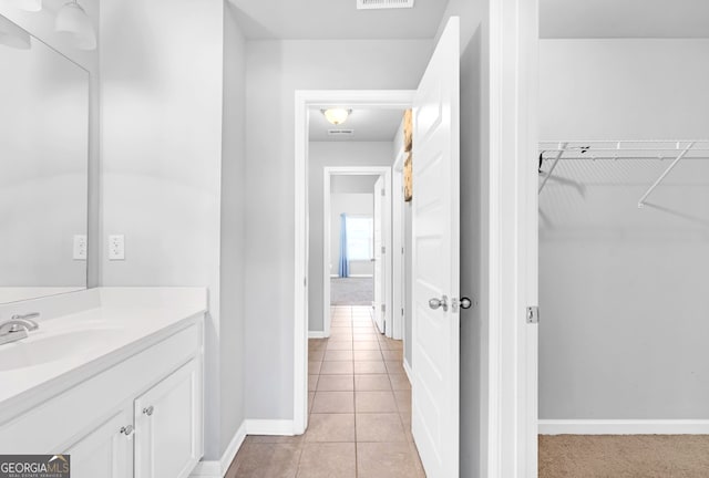 bathroom with tile patterned flooring and vanity