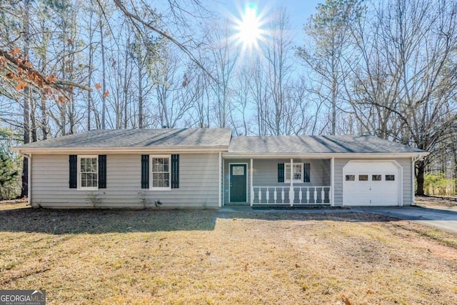 ranch-style house with a porch, a garage, and a front lawn