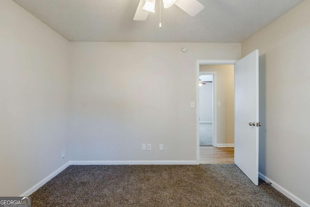 carpeted spare room featuring ceiling fan