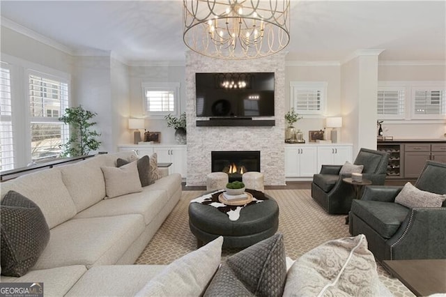 living room featuring hardwood / wood-style flooring, crown molding, beverage cooler, and a fireplace