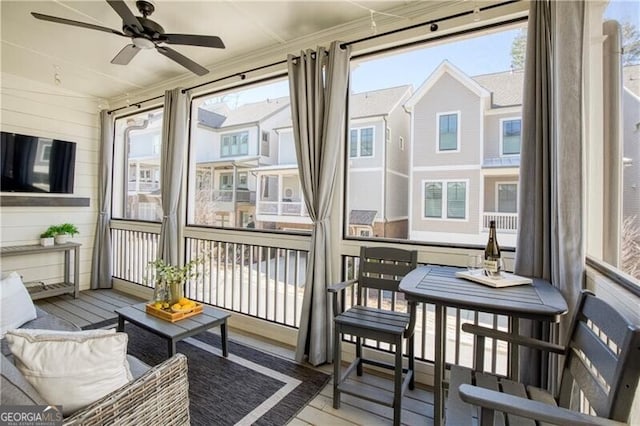 sunroom / solarium featuring a wealth of natural light and ceiling fan