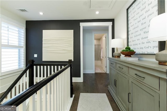 corridor with dark hardwood / wood-style flooring