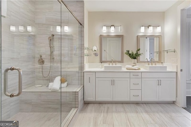 bathroom featuring vanity and a shower with door