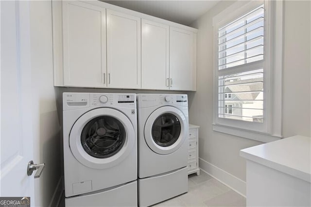 laundry room featuring cabinets and washing machine and clothes dryer