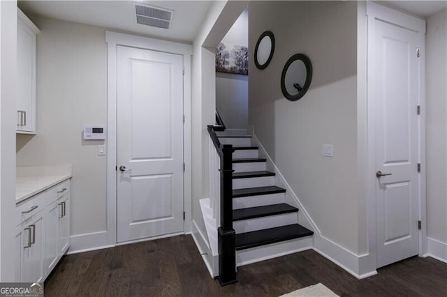 stairs featuring wood-type flooring