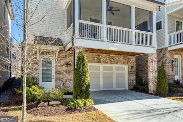 exterior space featuring a garage and ceiling fan