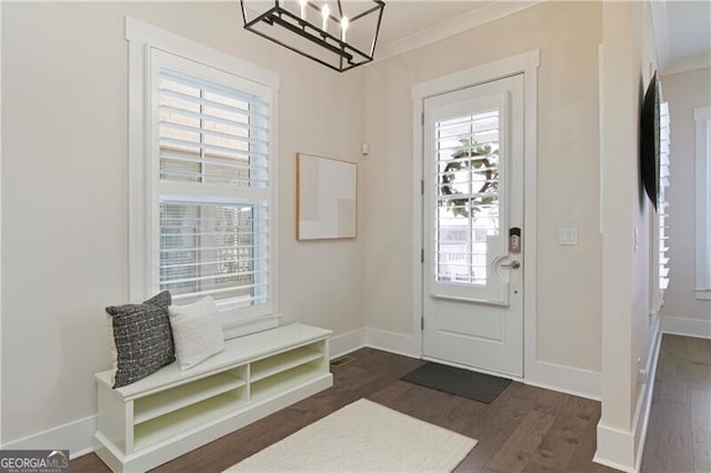 foyer featuring dark hardwood / wood-style flooring and crown molding