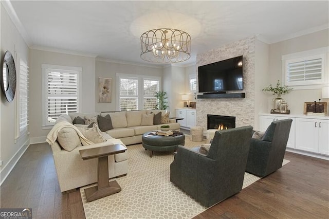 living room featuring a large fireplace, ornamental molding, and dark hardwood / wood-style floors