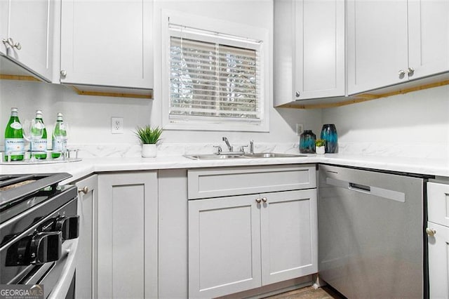 kitchen with white cabinetry, sink, and stainless steel appliances