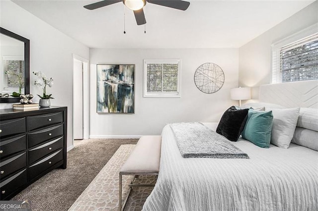 carpeted bedroom with ceiling fan and multiple windows