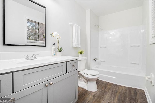 full bathroom featuring wood-type flooring, toilet, vanity, and  shower combination