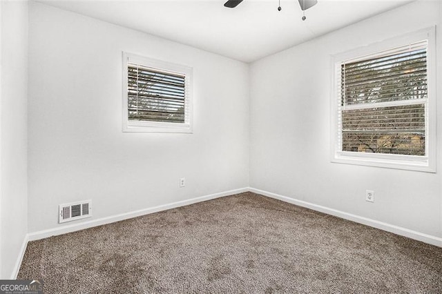 spare room with ceiling fan and carpet floors