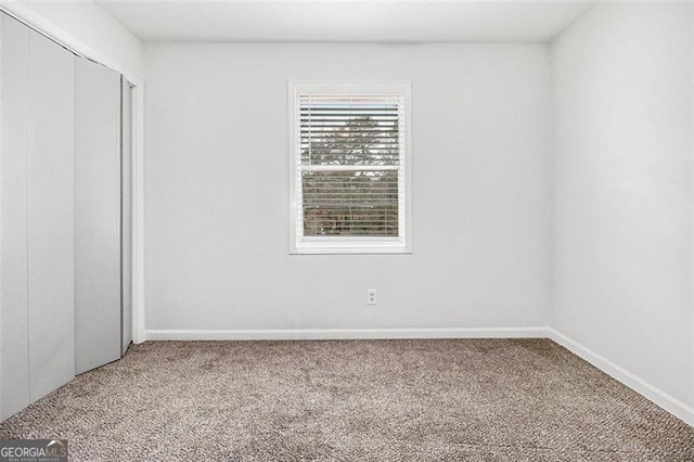 unfurnished bedroom with carpet flooring and a closet