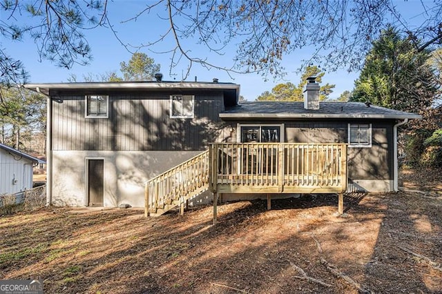 back of property featuring a wooden deck