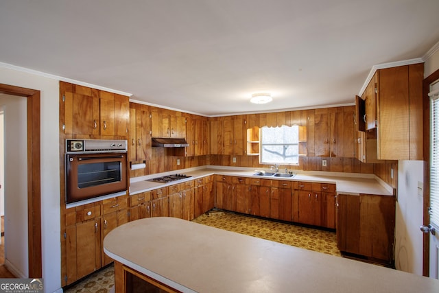 kitchen with sink, crown molding, oven, and stainless steel gas cooktop