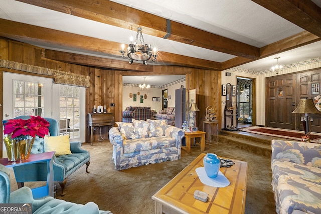 carpeted living room with beamed ceiling, wooden walls, and a chandelier