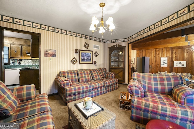 carpeted living room featuring a chandelier