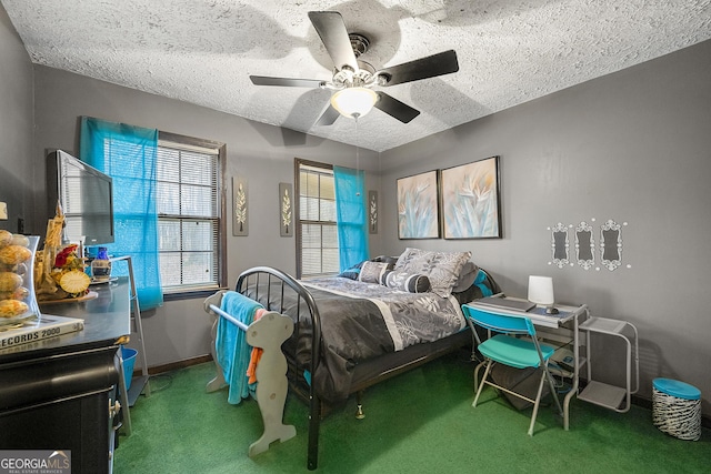 bedroom featuring ceiling fan, a textured ceiling, and carpet flooring