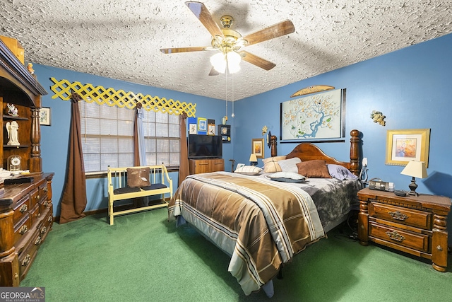 bedroom with ceiling fan, a textured ceiling, and dark colored carpet