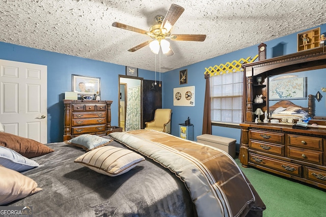 bedroom featuring ceiling fan, a textured ceiling, and dark carpet