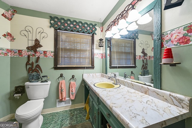 bathroom featuring vanity and toilet