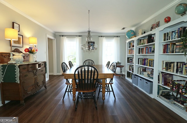 dining room with an inviting chandelier, ornamental molding, and dark hardwood / wood-style floors