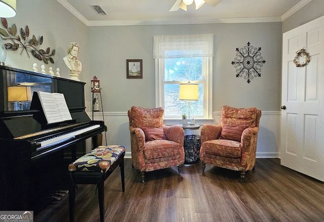 sitting room with dark hardwood / wood-style flooring, crown molding, and ceiling fan