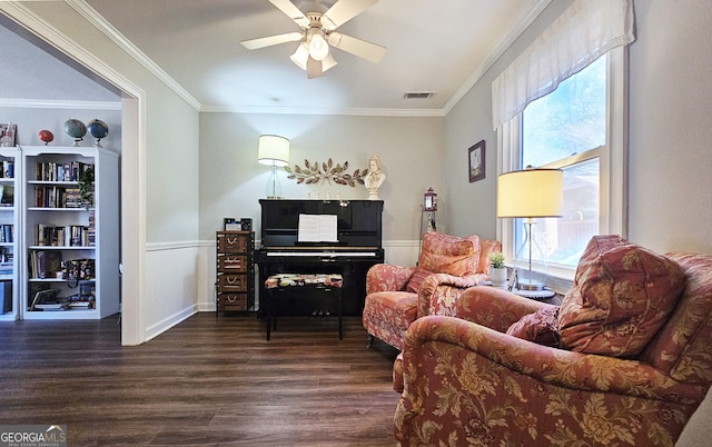 sitting room with dark hardwood / wood-style flooring, ornamental molding, and ceiling fan