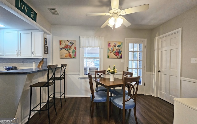 dining space with ceiling fan and dark hardwood / wood-style flooring