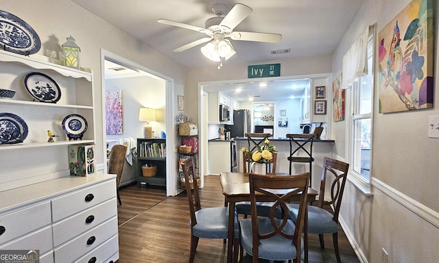 dining space featuring ceiling fan and dark hardwood / wood-style flooring