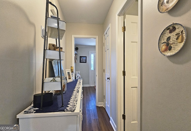 corridor with dark hardwood / wood-style flooring