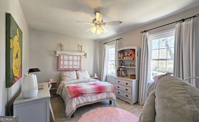 bedroom with light carpet and ceiling fan