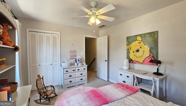 carpeted bedroom with ceiling fan and a closet