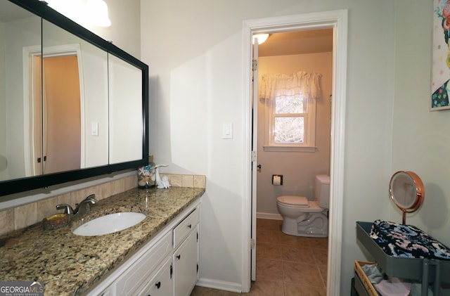 bathroom with vanity, tile patterned floors, and toilet