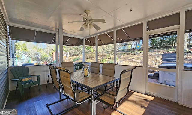 sunroom featuring ceiling fan