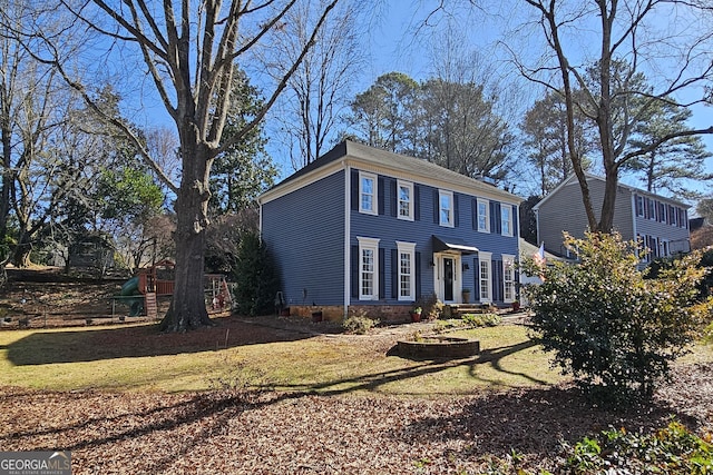 colonial home with a playground and a front lawn