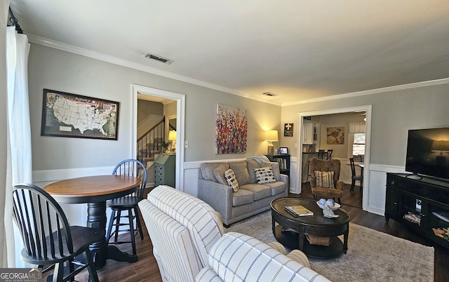 living room featuring crown molding and dark hardwood / wood-style flooring