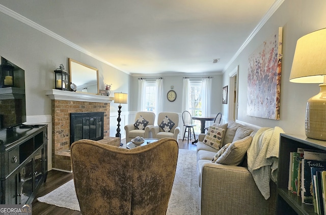 living room with dark hardwood / wood-style floors, ornamental molding, and a fireplace