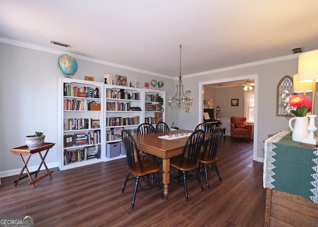 dining space with ornamental molding, dark hardwood / wood-style floors, and ceiling fan with notable chandelier