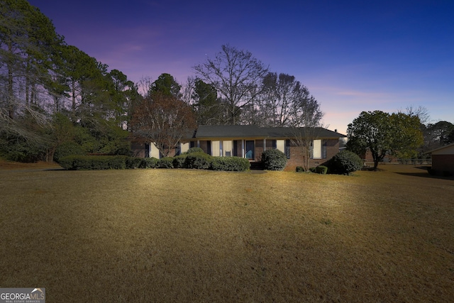 ranch-style house with a yard