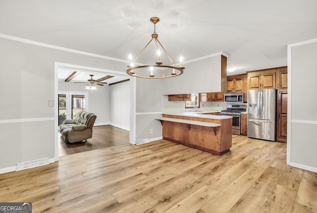 105 Skyline Dr, Barnesville, GA 30204 - kitchen featuring a peninsula, visible vents, light countertops, appliances with stainless steel finishes, and brown cabinetry
