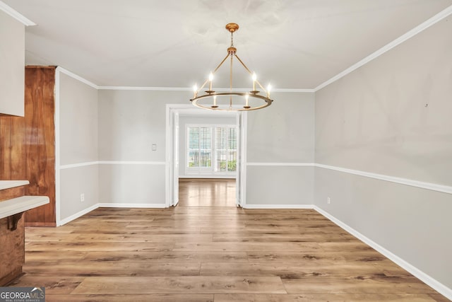 105 Skyline Dr, Barnesville, GA 30204 - unfurnished dining area featuring light wood-style flooring, ornamental molding, a chandelier, and baseboards