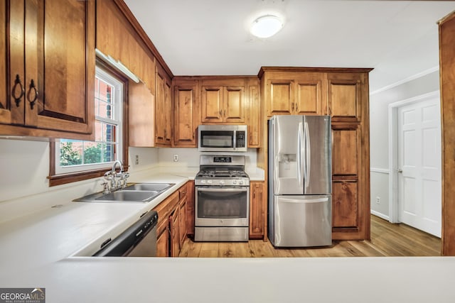 105 Skyline Dr, Barnesville, GA 30204 - kitchen featuring brown cabinets, stainless steel appliances, light countertops, a sink, and light wood-type flooring