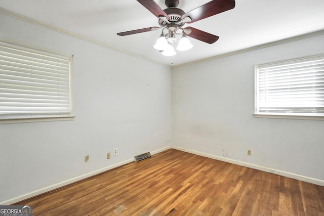 105 Skyline Dr, Barnesville, GA 30204 - spare room featuring wood finished floors, visible vents, a ceiling fan, baseboards, and ornamental molding