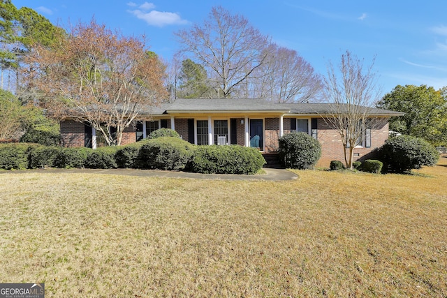 ranch-style house featuring brick siding and a front yard